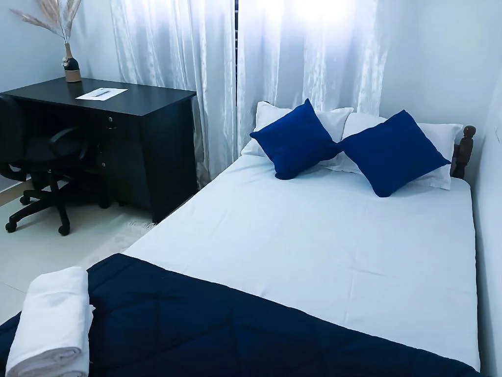 Guest bedroom with blue accents at Layanila